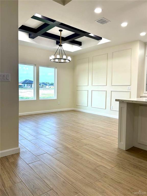 unfurnished dining area with recessed lighting, visible vents, light wood-style flooring, and a chandelier