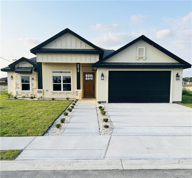 view of front facade featuring a front lawn, a garage, driveway, board and batten siding, and stucco siding