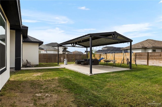 view of yard with a fenced backyard, a gazebo, and a patio area