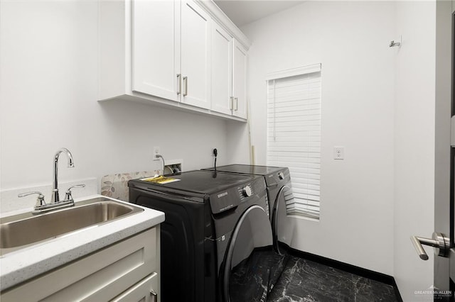 clothes washing area featuring baseboards, marble finish floor, cabinet space, a sink, and washing machine and dryer