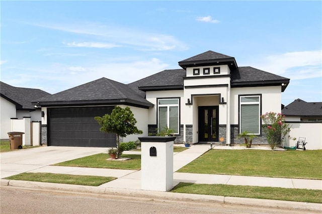 prairie-style house with driveway, stone siding, stucco siding, an attached garage, and a front lawn
