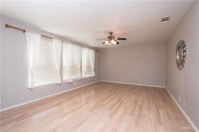 spare room featuring light hardwood / wood-style floors and ceiling fan