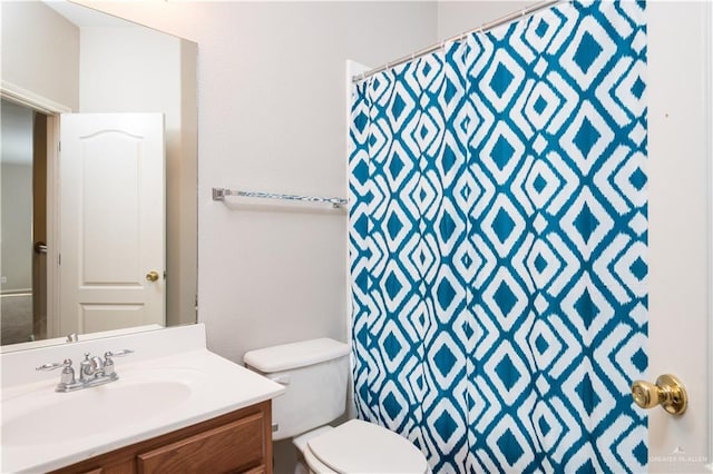 bathroom featuring vanity, a shower with curtain, and toilet