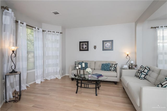 living room with plenty of natural light and light wood-type flooring