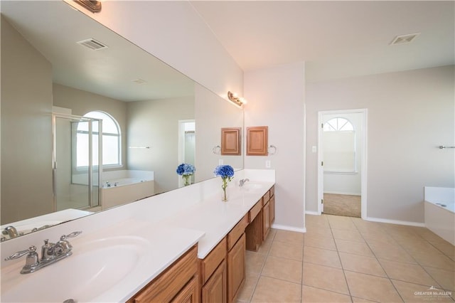 bathroom featuring vanity, plus walk in shower, and tile patterned flooring