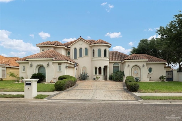 2201 W Rhin Dr, Edinburg, TX 78539 - mediterranean / spanish home with driveway, an attached garage, stucco siding, and a tile roof