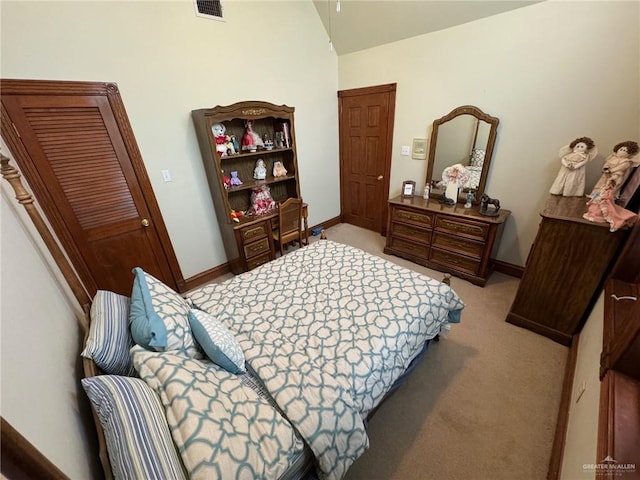 bedroom with light carpet and vaulted ceiling