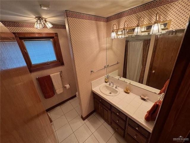 bathroom featuring tile patterned floors, vanity, and walk in shower