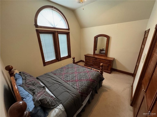 bedroom featuring light colored carpet and vaulted ceiling