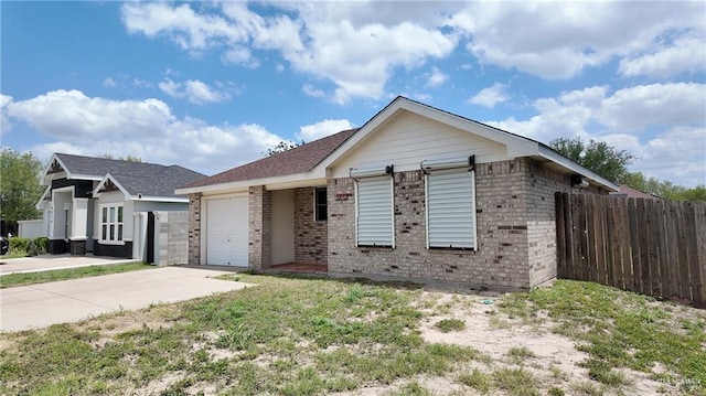 9212 N 30th St, Mcallen, TX 78504 - view of front of property with brick siding, an attached garage, concrete driveway, and fence
