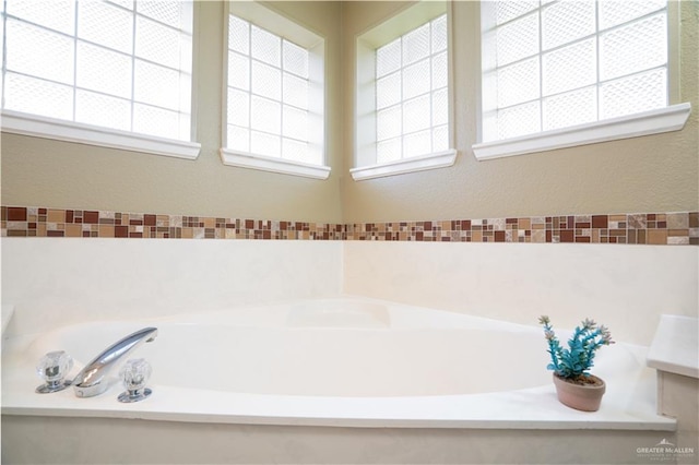 bathroom featuring a bathtub and a healthy amount of sunlight