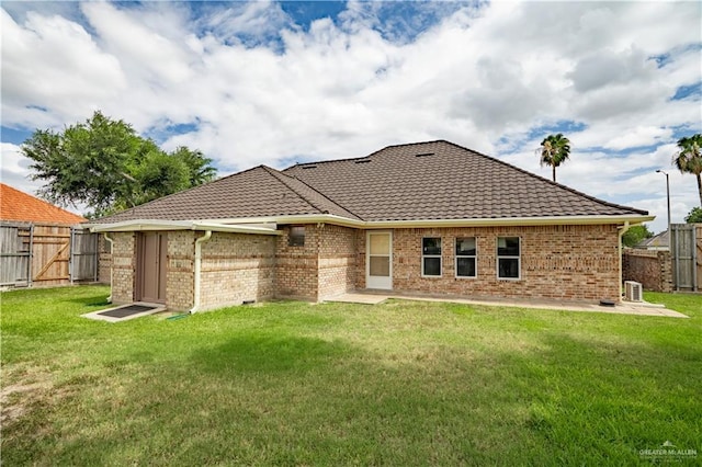 back of house with a lawn