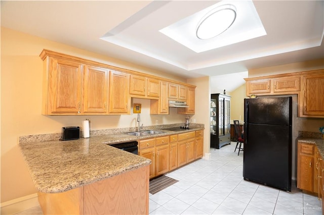 kitchen featuring black appliances, light tile patterned flooring, sink, and a tray ceiling