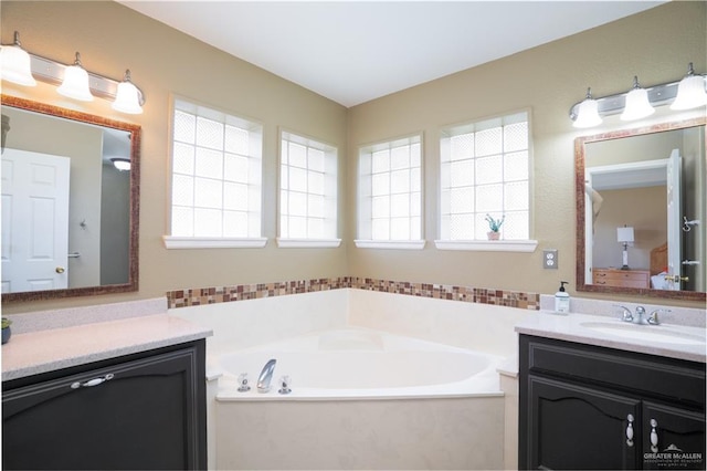 bathroom featuring vanity and a bath