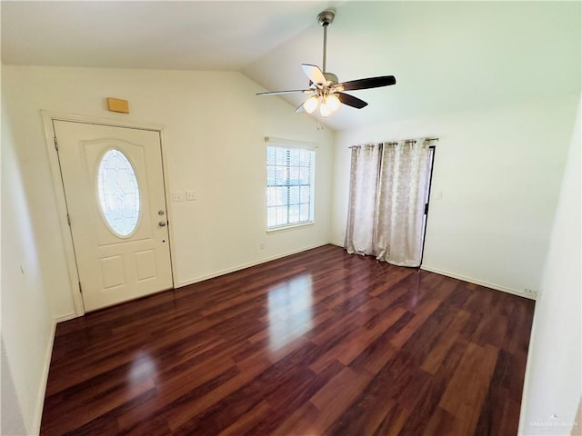 foyer entrance with dark hardwood / wood-style floors, ceiling fan, and vaulted ceiling