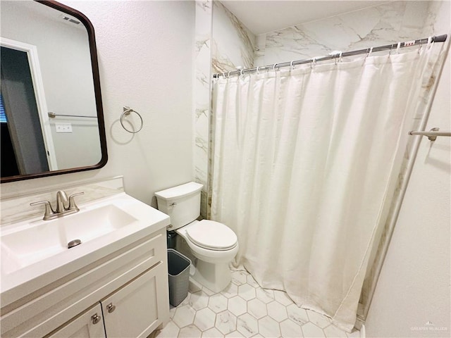 bathroom with tile patterned flooring, vanity, toilet, and a shower with shower curtain