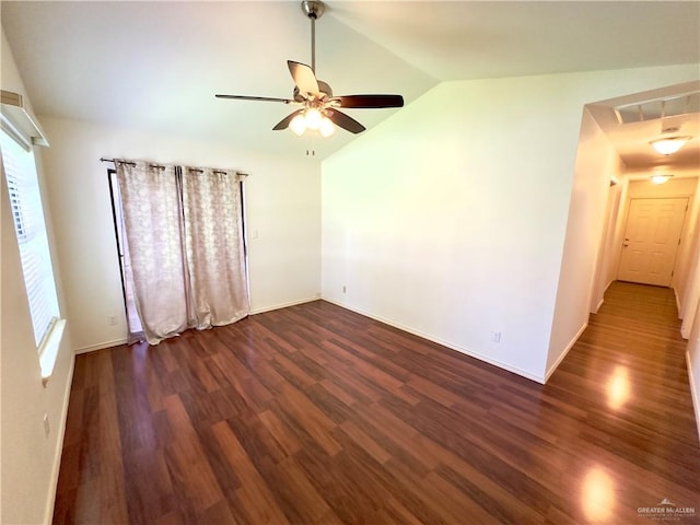 empty room featuring ceiling fan, dark wood-type flooring, and vaulted ceiling