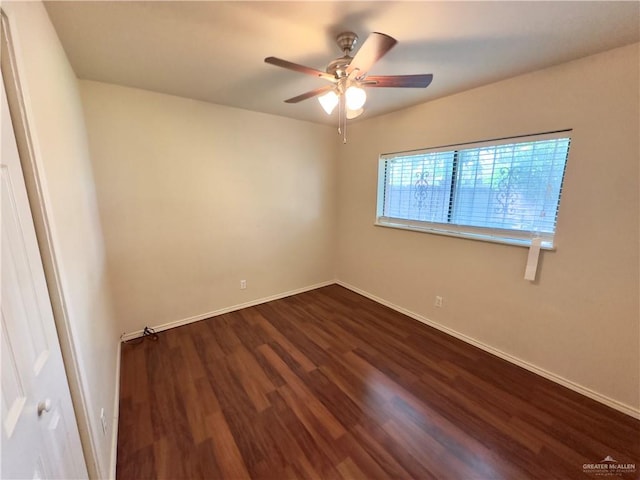 empty room featuring ceiling fan and dark wood-type flooring