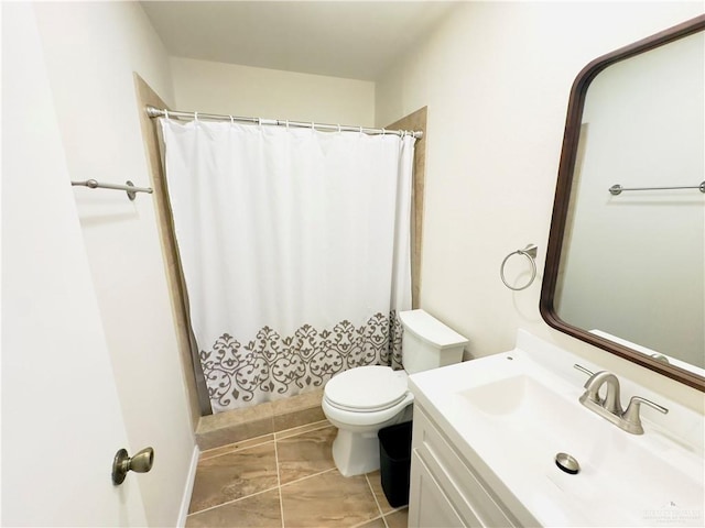 bathroom with walk in shower, vanity, and toilet