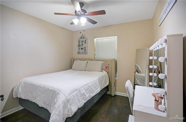 bedroom featuring a ceiling fan, baseboards, and wood finished floors