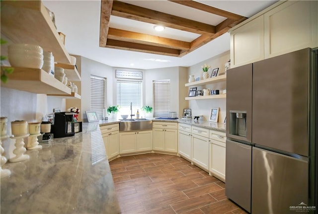 kitchen with open shelves, beamed ceiling, a sink, and stainless steel fridge with ice dispenser