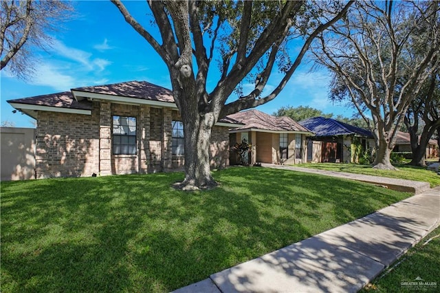 view of front of house with brick siding and a front yard