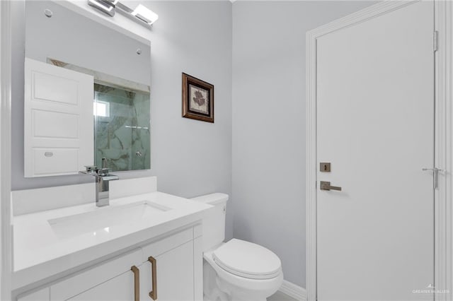 6073 Surrey Ln, Brownsville, TX 78526 - bathroom with toilet, vanity, and baseboards
