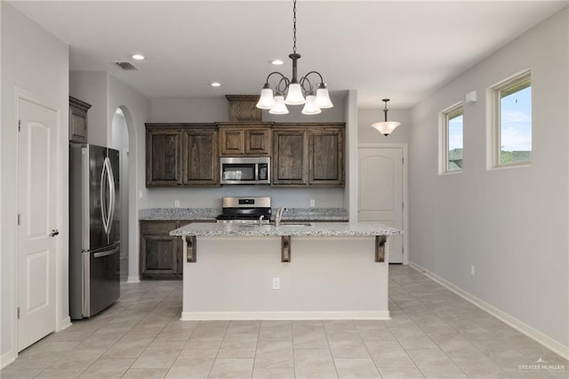 kitchen featuring recessed lighting, visible vents, a sink, arched walkways, and appliances with stainless steel finishes