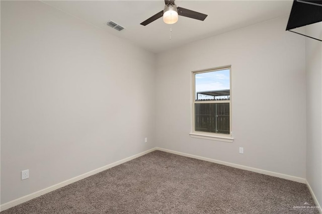 empty room with ceiling fan, baseboards, carpet flooring, and visible vents