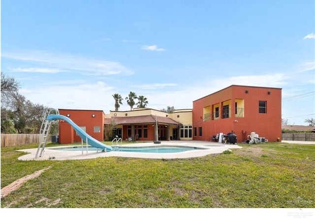 view of pool featuring a lawn and a water slide