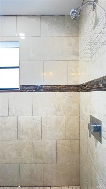 interior details featuring a tile shower