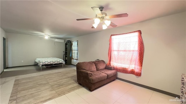 living area with ceiling fan, an AC wall unit, and baseboards