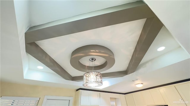 room details with a raised ceiling and recessed lighting