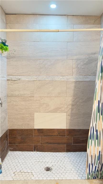 full bath with a tile shower