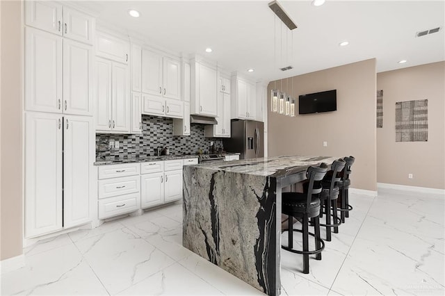 kitchen with visible vents, decorative backsplash, marble finish floor, and stainless steel fridge with ice dispenser