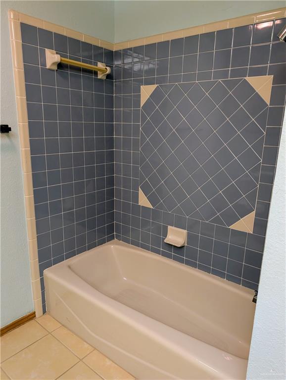 bathroom featuring tile patterned flooring and bathtub / shower combination