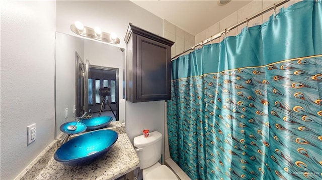 bathroom with tile patterned flooring, vanity, toilet, and a shower with curtain