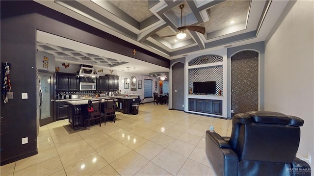 tiled living room with ceiling fan and coffered ceiling