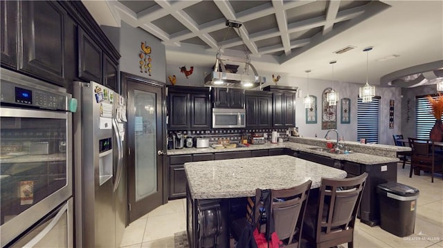 kitchen with a breakfast bar, coffered ceiling, light tile patterned floors, beamed ceiling, and stainless steel appliances