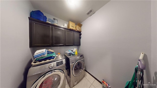 washroom featuring light tile patterned floors, cabinets, and independent washer and dryer