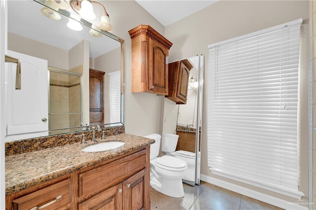 bathroom with toilet, tile patterned flooring, a shower with shower door, and vanity