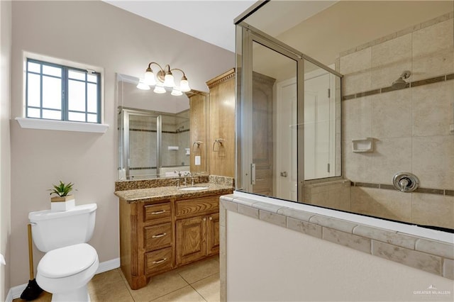 bathroom featuring vanity, tile patterned flooring, toilet, and walk in shower