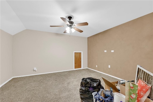 unfurnished room featuring ceiling fan, lofted ceiling, and carpet floors