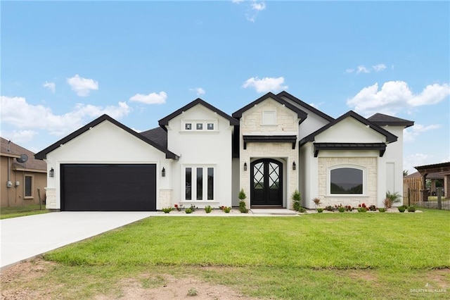 15439 E Davis Rd, Edinburg, TX 78542 - french provincial home with stone siding, a front yard, an attached garage, concrete driveway, and stucco siding