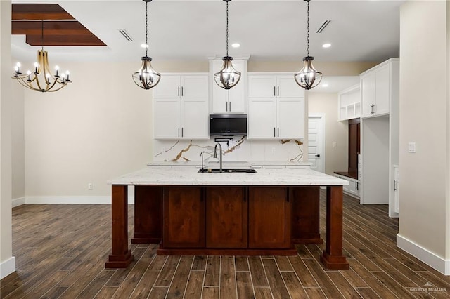15439 E Davis Rd, Edinburg, TX 78542 - kitchen with dark wood finished floors, baseboards, a chandelier, white cabinets, and recessed lighting