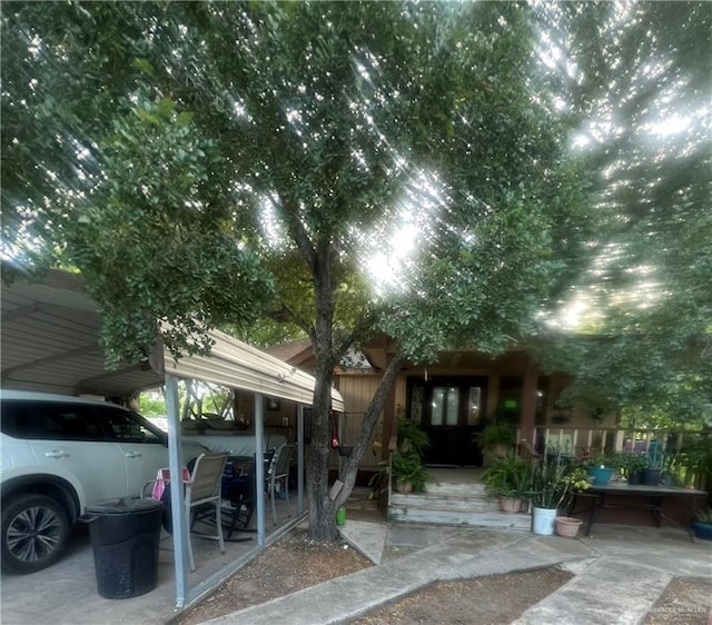 view of vehicle parking with a carport