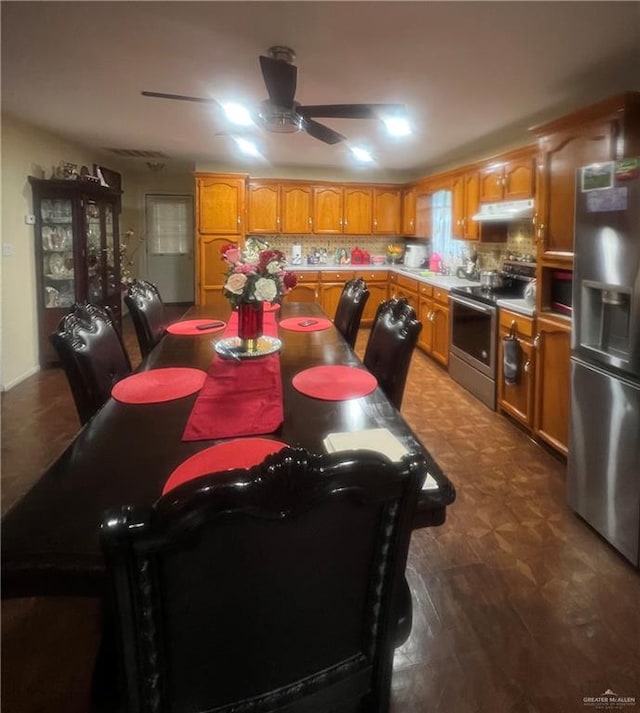 dining area with ceiling fan and dark wood-type flooring