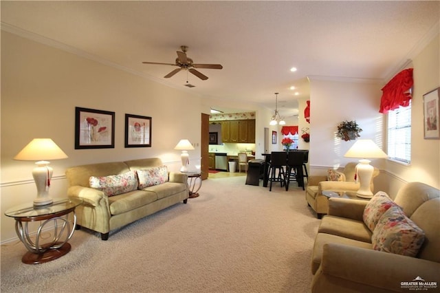 carpeted living room featuring ceiling fan with notable chandelier and crown molding