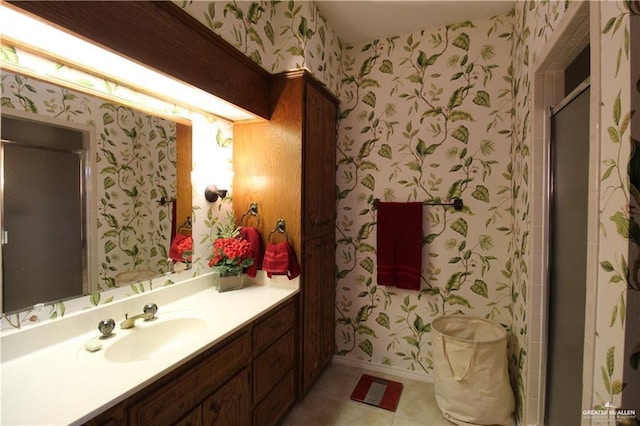 bathroom with tile patterned floors, vanity, and a shower with door