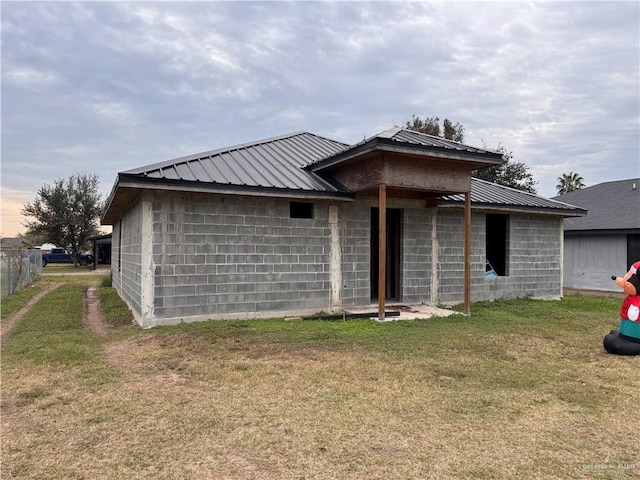 back of property featuring a lawn